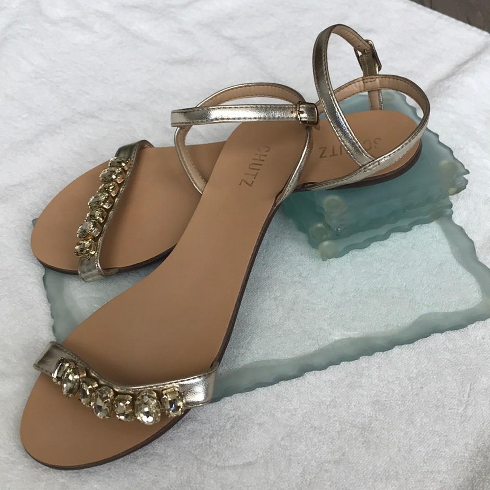 Gold jeweled sandals.